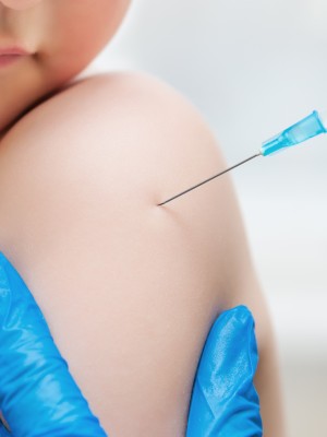 Boy and vaccine syringe