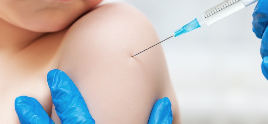 Boy and vaccine syringe