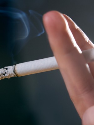 Woman's fingers with smoking cigarette