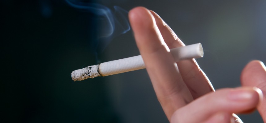 Woman's fingers with smoking cigarette